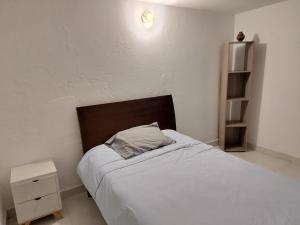 a bedroom with a bed with a pillow on it at Posada San Jorge in Pacho