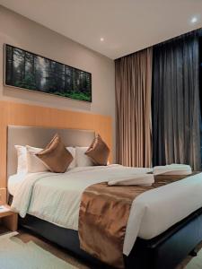 a bedroom with a large bed and a window at Greens Hotel & Suites in Bintulu +71 photos