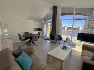 a living room with a couch and a table at Aquaronde 093 in Lemmer