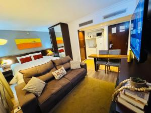 a living room with a couch and a bedroom at Blu Flat Prime Verbo Divino in São Paulo +41 photos