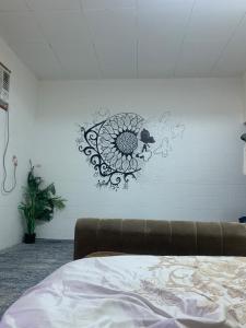 a wall with a sticker of a sunflower on it at Rooms & Suites Western Dhafra Housing in Ghayathi