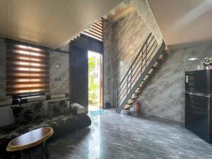 a living room with a couch and a staircase at Centralhome 2 in Plei Brêng