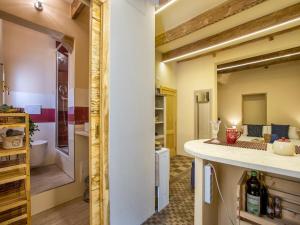 a kitchen with a counter and a toilet in a room at Monolocale in centro storico in Alghero +32 photos
