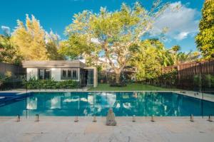 a swimming pool in front of a house at Mokum House Designer Escape with Pool Sauna in Brisbane