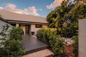 a house with a wooden walkway in front of it at Mokum House Designer Escape with Pool Sauna in Brisbane