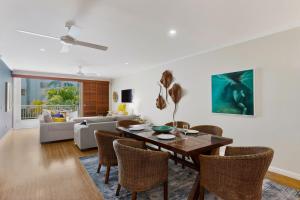 a living room with a dining room table and chairs at Tidal Haven in Noosaville +10 photos