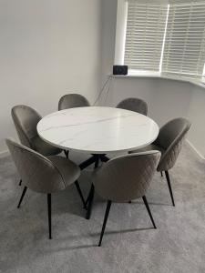 a white table and chairs in a room at Blackburn House for Professionals in Blackburn