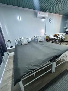a large bed in a room with a table at TeeDo Zzz in Parit Buntar