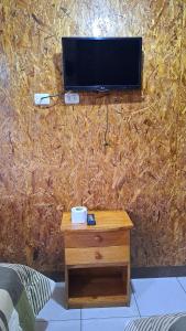 a tv on top of a wall with a table at Hospedaje El Manantial in Chontabamba +39 photos