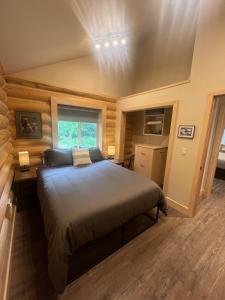 a bedroom with a large bed and a window at Clear Creek Cabins in Seward