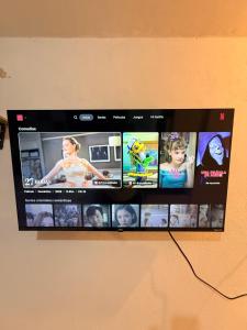 a television screen with a bunch of pictures on it at Private Loft Free Parking Pet friendly in Chapulco