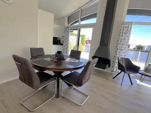 a dining room with a table and chairs and a fireplace at Aquaronde 093 in Lemmer