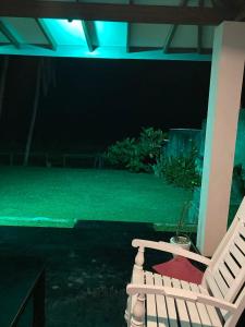 a white chair sitting on a patio at night at Dragon beach in Dondra West