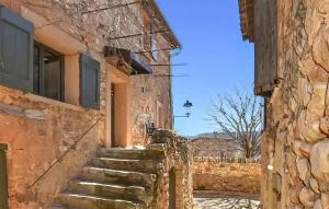 a stone building with stairs leading up to a door at Maison En Pierres in Rustrel +13 photos