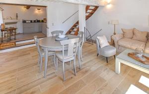a living room with a table and chairs and a couch at Maison En Pierres in Rustrel