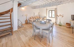 a living room with a table and chairs and a couch at Maison En Pierres in Rustrel