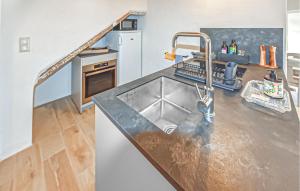 a kitchen with a sink and a counter top at Maison En Pierres in Rustrel