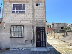 a door in the side of a brick building at Private Loft Free Parking Pet friendly in Chapulco