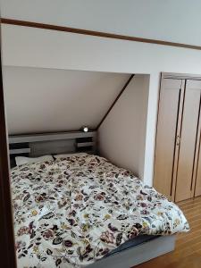 a bed with a floral comforter in a bedroom at シンデレラ城風 邸宅のゲストハウス民泊 in Tosa