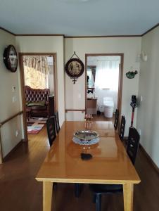 a dining room with a wooden table and chairs at シンデレラ城風 邸宅のゲストハウス民泊 in Tosa
