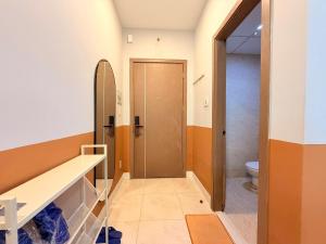 a bathroom with a door and a toilet at Ocean Dream Apartment Nha Trang in Nha Trang +179 photos