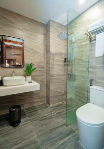 a bathroom with a toilet and a sink and a shower at Intechco Hotel S1-25 sầm Sơn in Sầm Sơn