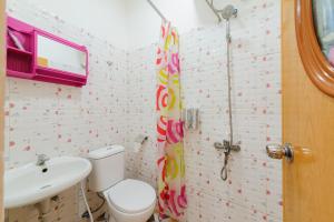 a bathroom with a toilet and a sink at Sans Hotel Cengkareng in Jakarta +16 photos