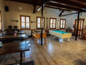 Habitación grande con varias mesas y mesa de billar. en Camping Valle de Hecho, en Hecho