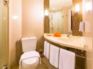 a bathroom with a toilet and a sink at Ibis Phuket Kata in Kata Beach