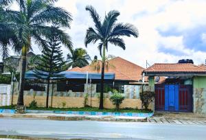 a house with palm trees in front of a street at Mauya Executive Lodge in Dar es Salaam