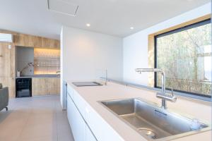 a kitchen with a sink and a large window at Villa CASK Setouchi in Mitoyo +52 photos