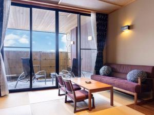 a living room with a couch and a table at Manten no Yado in Gujo