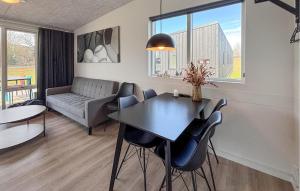 a living room with a table and chairs and a couch at 2 Bedroom Nice Apartment In Vejen in Vejen