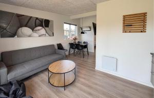 a living room with a couch and a table at 2 Bedroom Nice Apartment In Vejen in Vejen