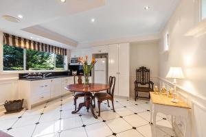 a kitchen with a table and a dining room at The Castle on Tamborine in Mount Tamborine
