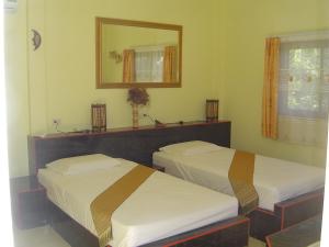 En eller flere senge i et værelse på Mini-golf **** & Resort Ubon Ratchathani