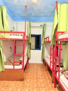 a room with three bunk beds in a room at Vang Vieng Freedom View Hostel in Ban Khouaphan
