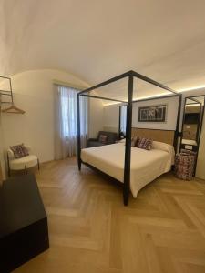 a bedroom with a bed with a canopy at Fourteensuitetropea in Tropea