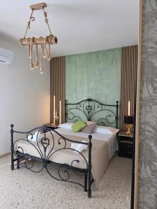 a bedroom with a large bed and a mirror at Casa a Pennello Bed & Breakfast - Dove l'arte incontra l'ospitalità in San Benedetto del Tronto