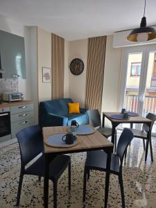 a living room with two tables and a blue couch at Casa a Pennello Bed & Breakfast - Dove l'arte incontra l'ospitalità in San Benedetto del Tronto