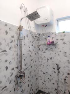 a shower in a bathroom with a shower head at NRS Villa Midigama in Midigama East +23 photos