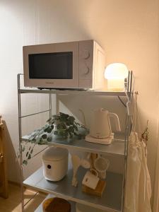 a microwave oven sitting on top of a shelf at juns house in Ulsan