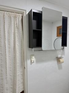 a bathroom with a mirror and a shower curtain at juns house in Ulsan