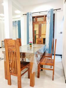 a dining room with a table and chairs at NRS Villa Midigama in Midigama East