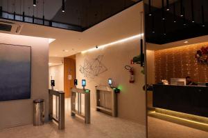 a lobby with two elevators in a building with a screen at Skylux by Tegra in Rio de Janeiro