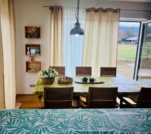 a dining room with a table and chairs and a window at Ubytování Jitřenka in Černá Voda +28 photos