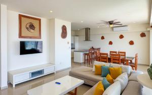 a living room with a couch and a table at Grand Boréna Hotel Boutique in Playa del Carmen