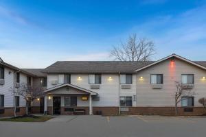 a large white building with a parking lot at Super 8 by Wyndham Mentor/Cleveland Area in Mentor