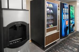 a refrigerator and a television in a room at Super 8 by Wyndham Mentor/Cleveland Area in Mentor