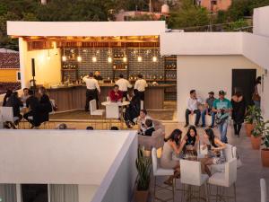 a group of people sitting at tables on a rooftop restaurant at Eloína Hotel Boutique in Chiapa de Corzo